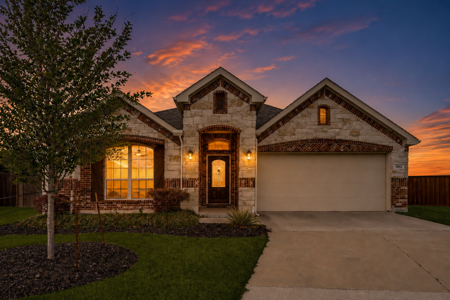 Front exterior of 1913 Elite Rd, a stone single-story home in North McKinney, TX at dusk